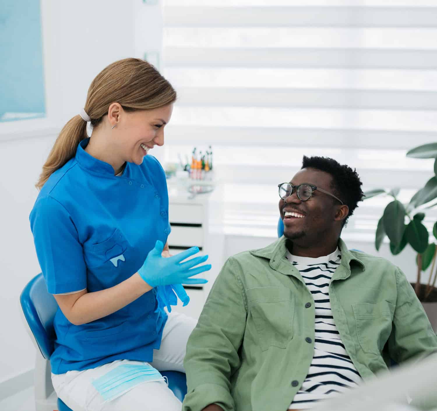 Men smiling talking to a dentist