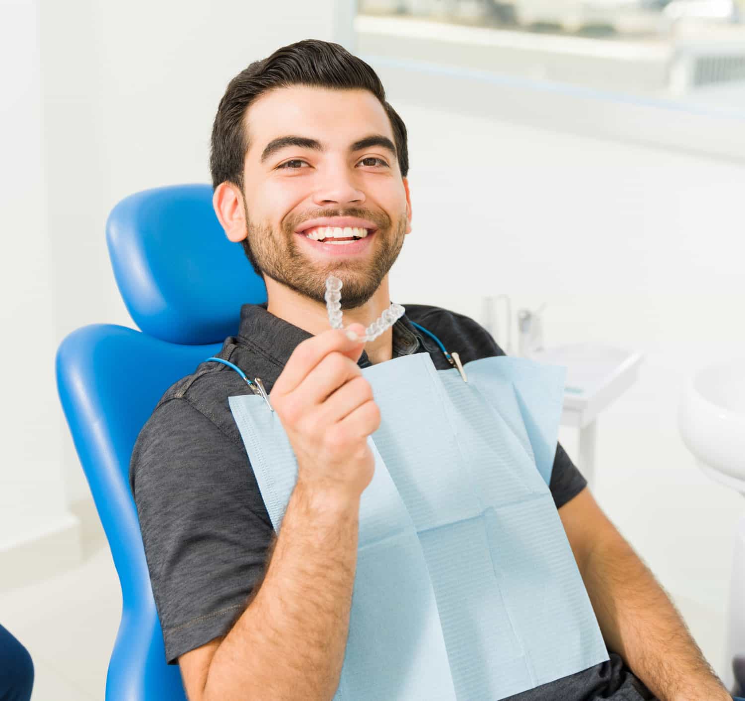 Smiling patient in a dentist chair