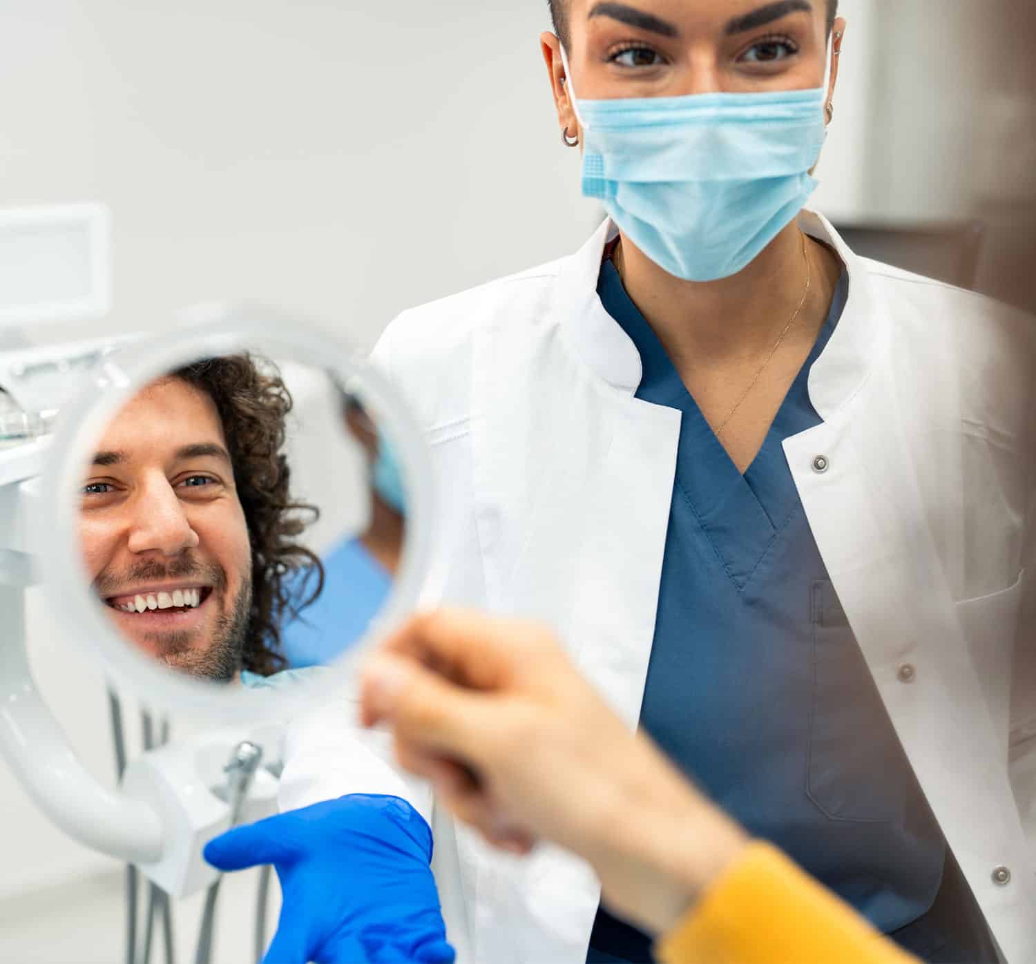 Joyful male is lying in chair and looking into mirror while being delighted with dentist work