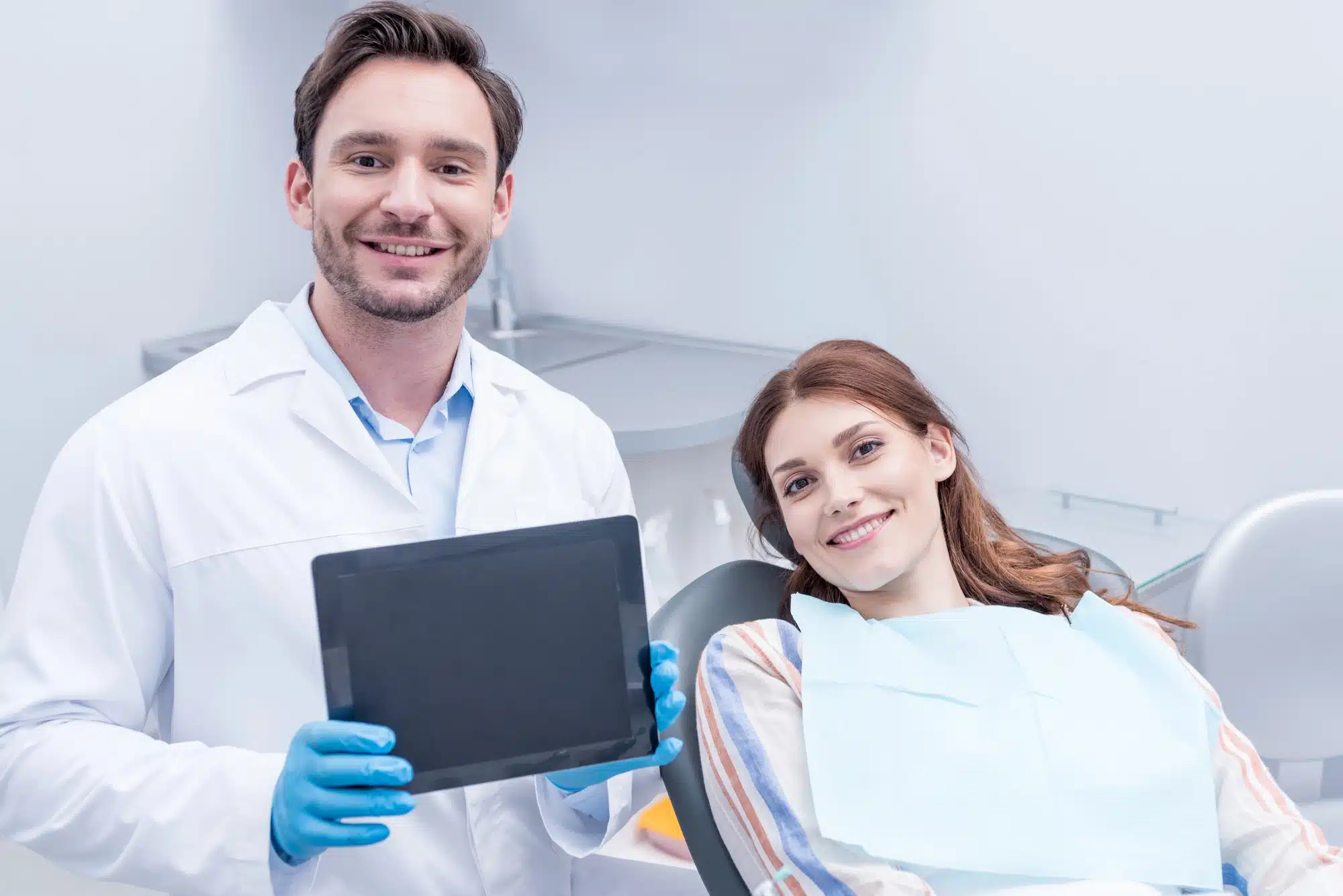 dentist and patient after getting dental implants in Grosse Pointe, MI