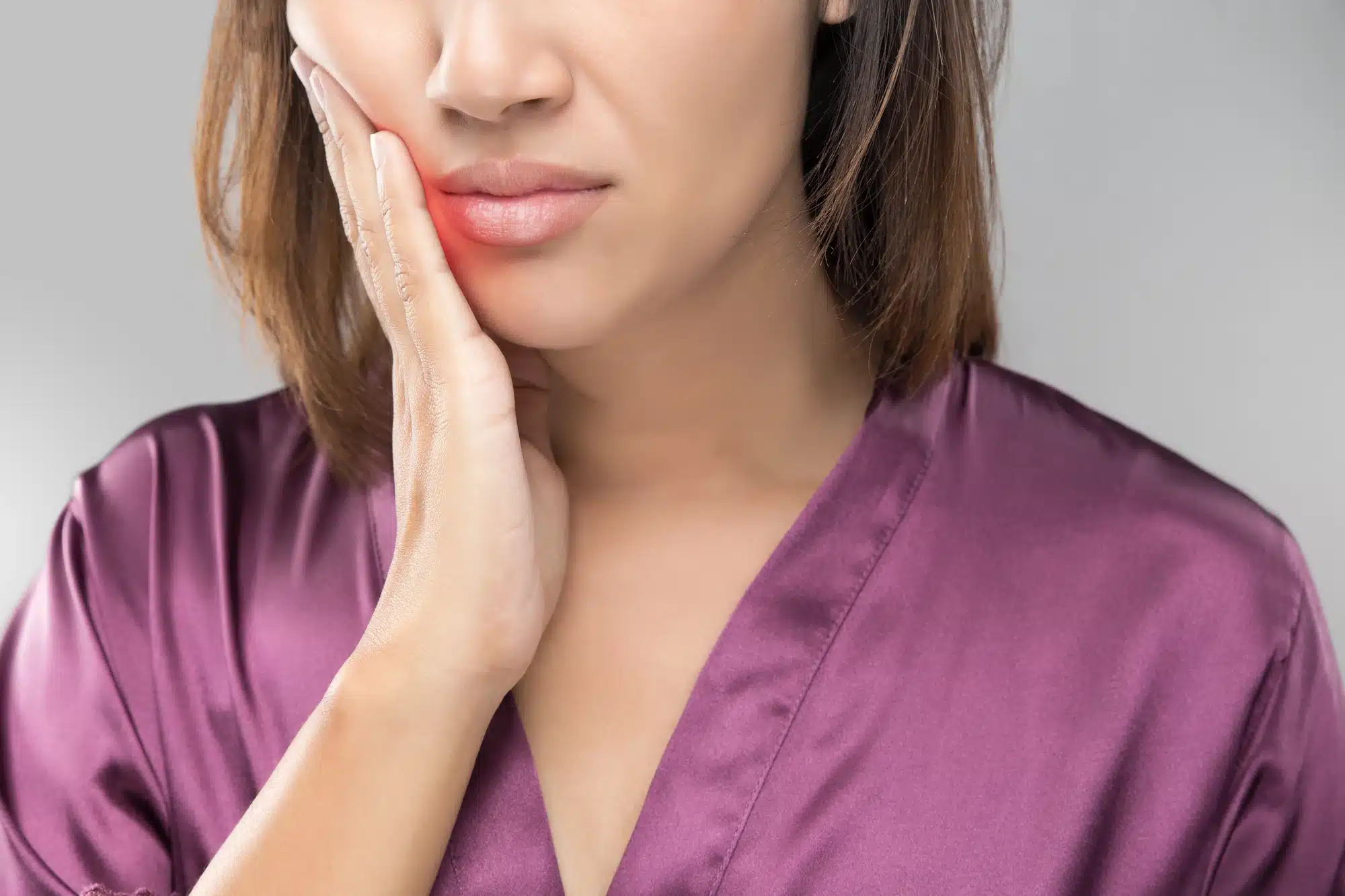 woman in pain before going to a general dentist in Grosse Pointe Woods