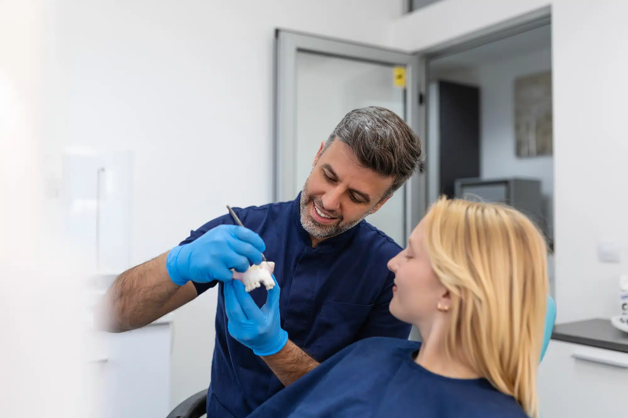 dentist explaining dental bridges in Grosse Pointe, MI